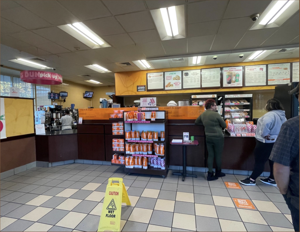 Dunkin’ interior showing the counter to order and the area to pick up right next to it. 