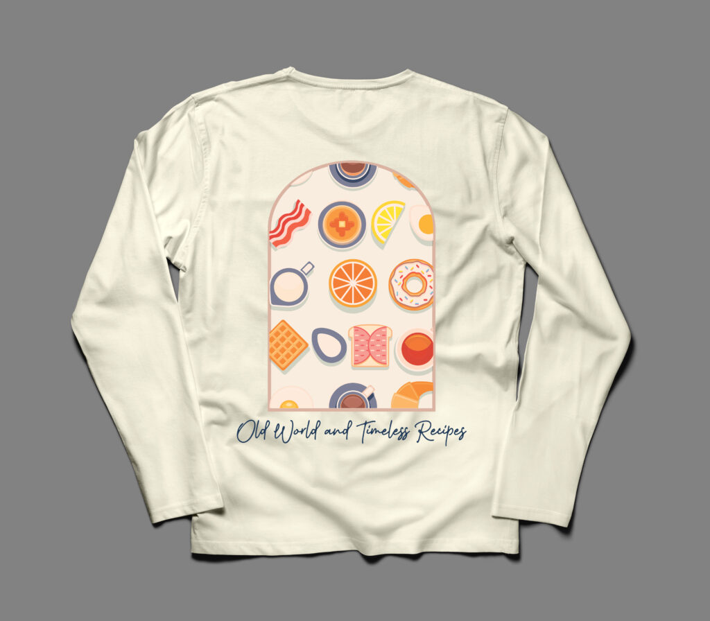 Back of cream long sleeve t-shirt. with breakfast foods in an arch with the value prop “old world and timeless recipes” underneath the arch. 